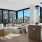 a modern looking living room with large windows overlooking a city