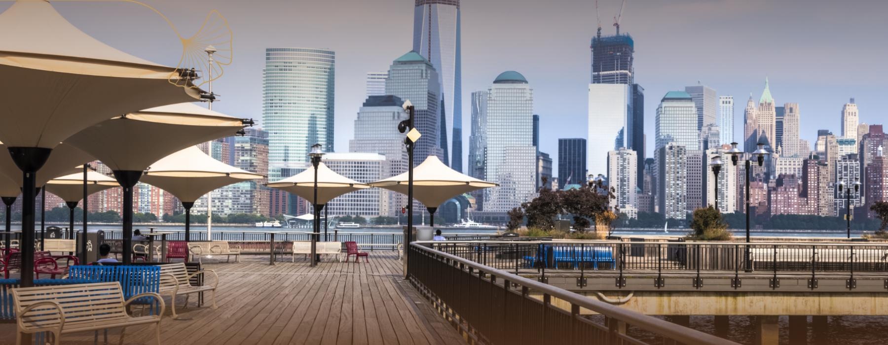 a boardwalk with a city skyline in the background