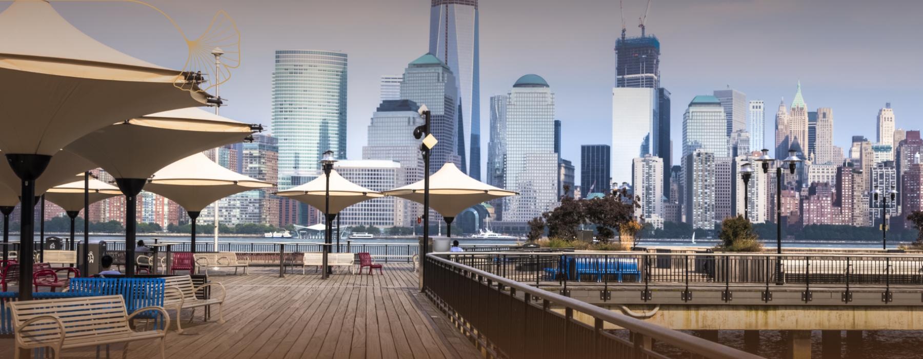 a boardwalk with a city skyline in the background