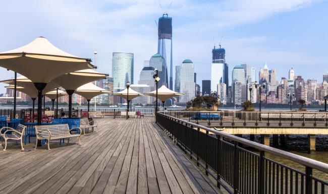 Close to the center of everything a boardwalk with a city in the background