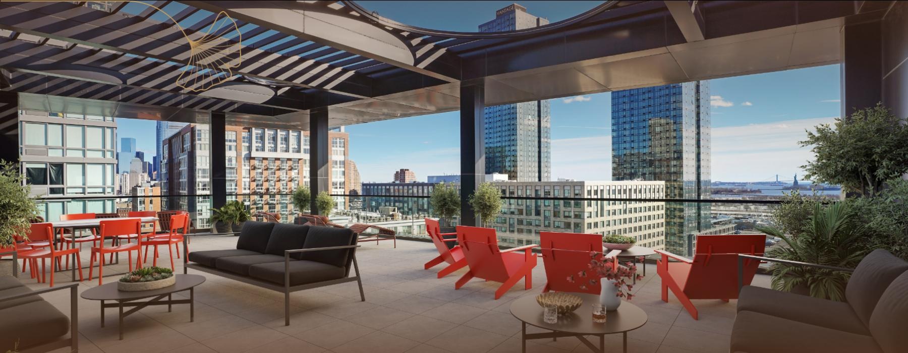 a rooftop patio with a table chairs in a downtown setting