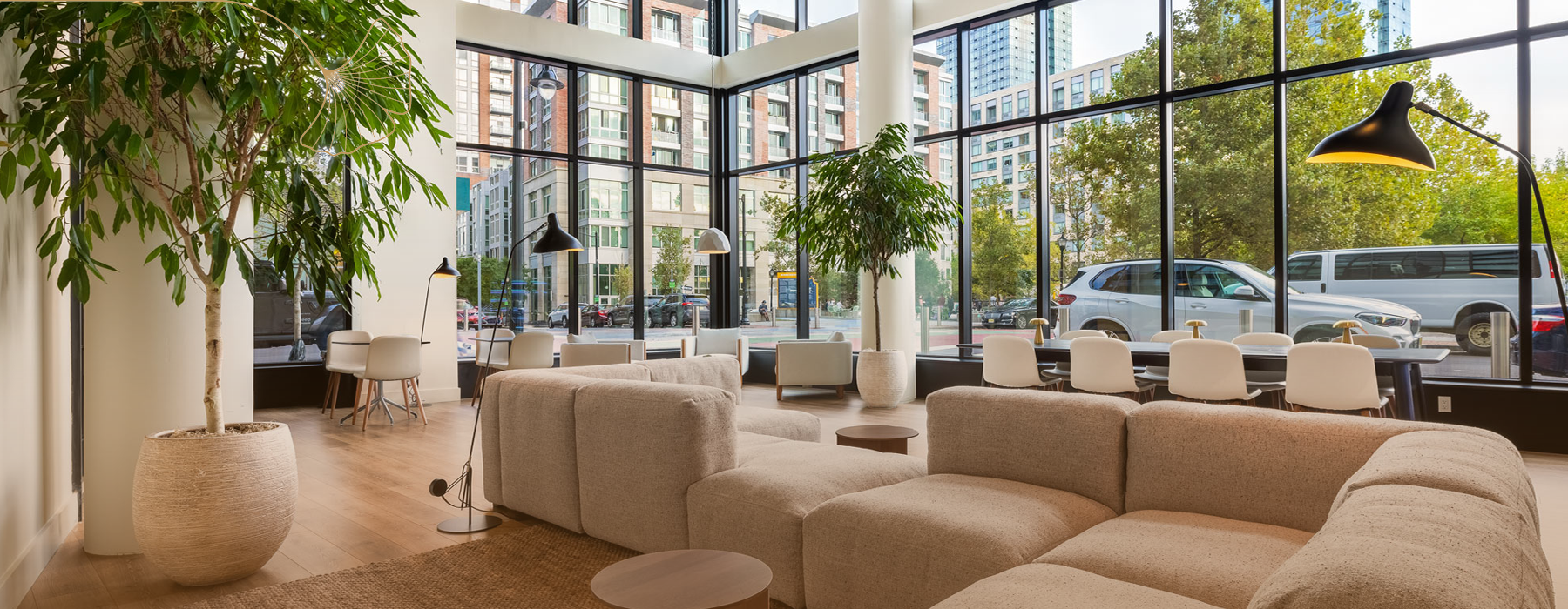 a room with large windows and a couch and chairs