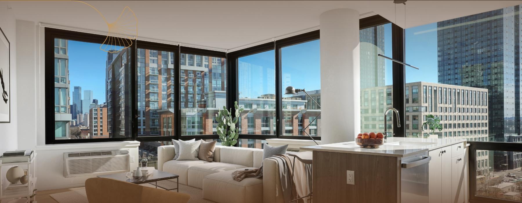 a room with a couch and a table with a window with a view of a city